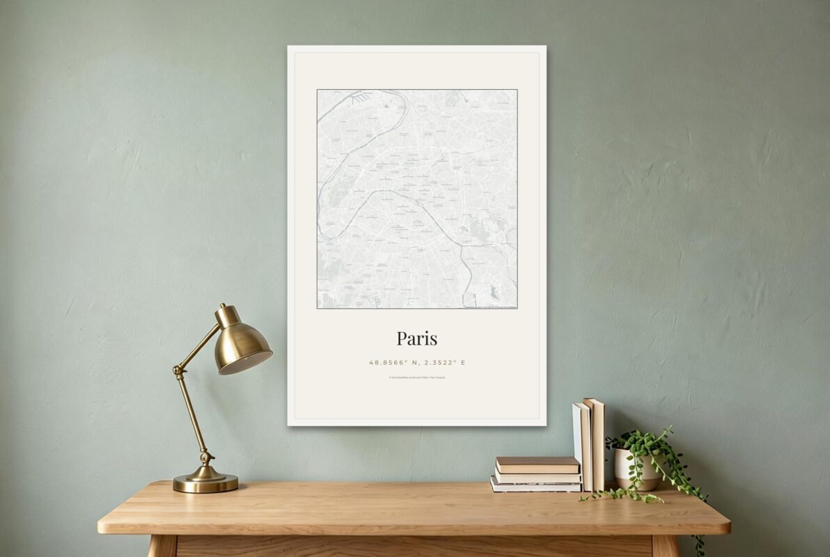 White framed Paris city map poster above a wooden desk