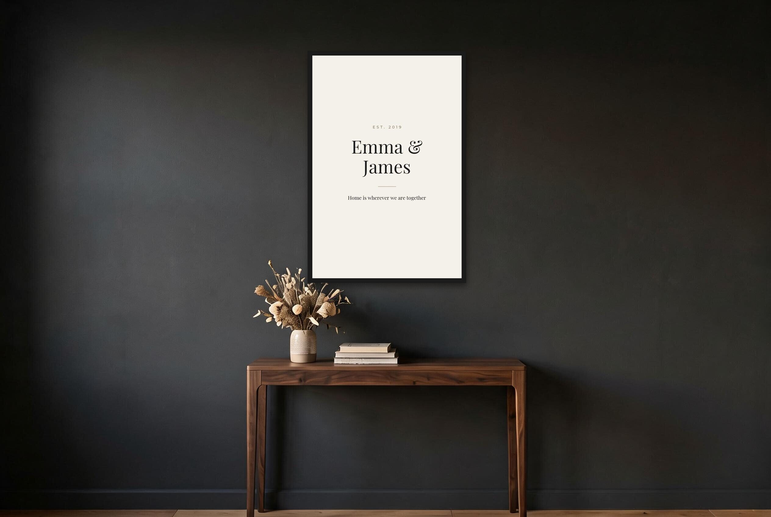 Personalised couple name poster in ivory on a dark hallway wall