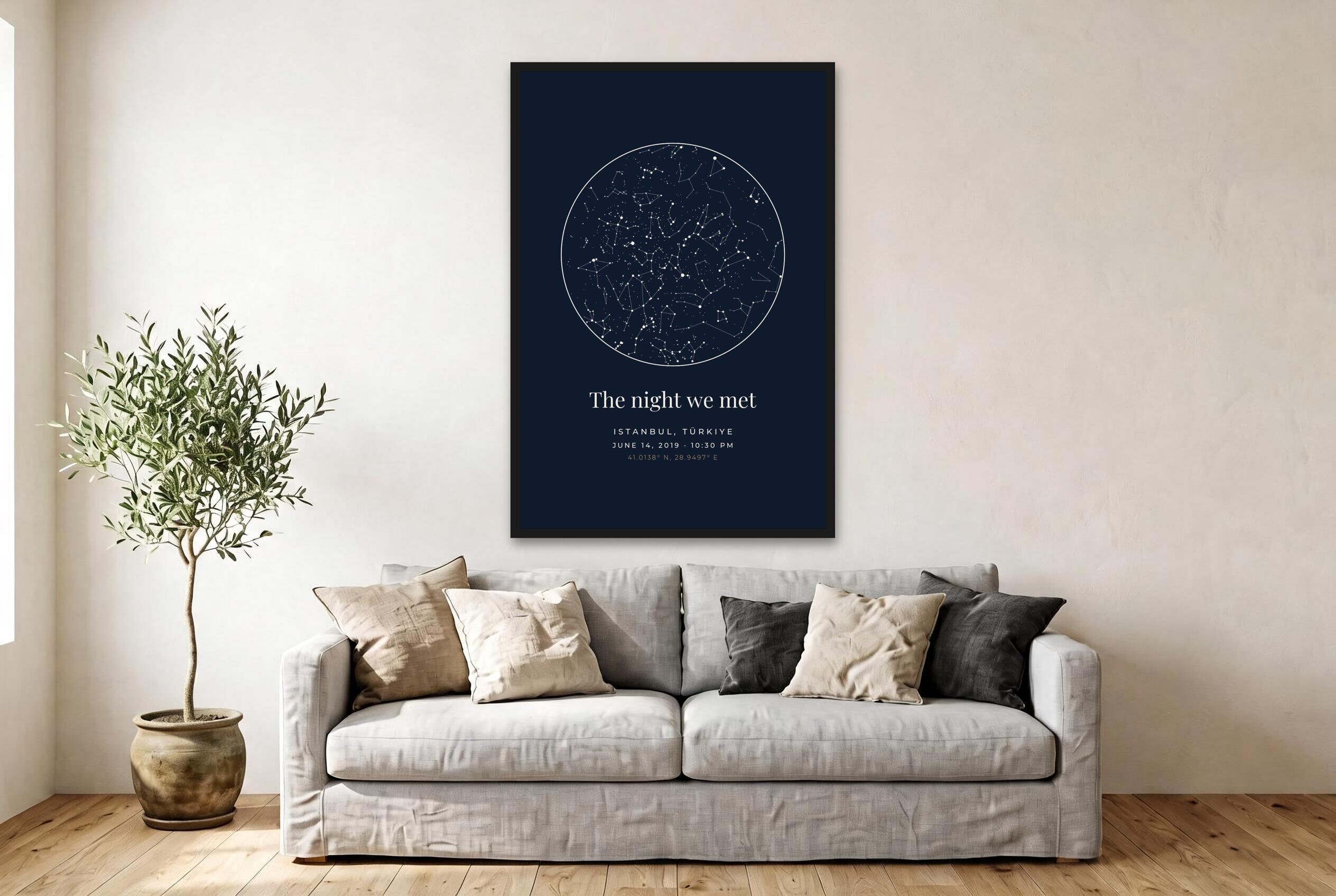 Custom star map poster in midnight blue above a sofa in a Scandinavian living room